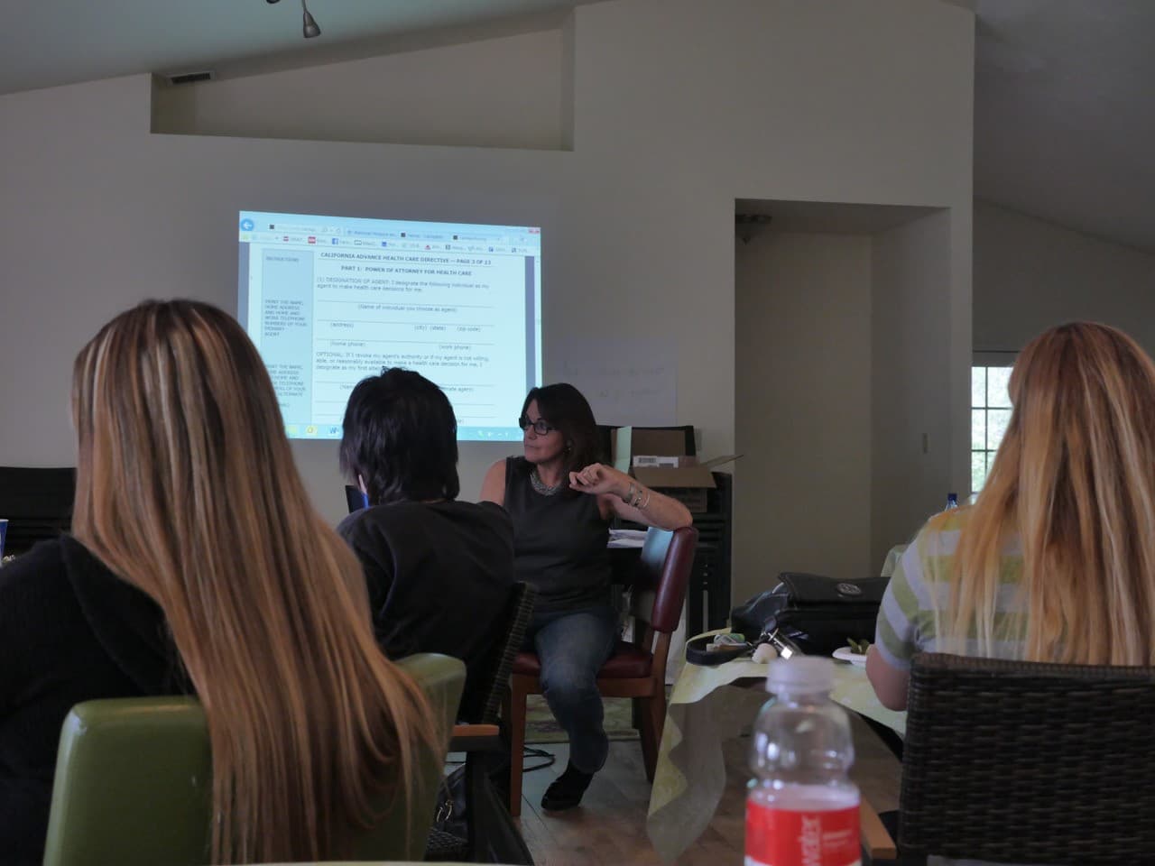 Leigh Ann Kingsbury leading an Advance Care Planning session, with a California Advance Health Care Directive shown on a screen